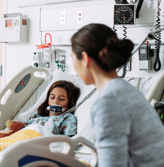 Pediatric patient in bed with parent